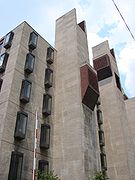 A tall, jagged gray building with protruding windows