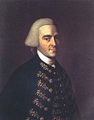 Half-length portrait of a man with a hint of a smile. His handsome features suggests that he is in his 30s, although he wears an off-white wig in the style of an English gentleman that makes him appear older. His dark suit has fancy embroidery.